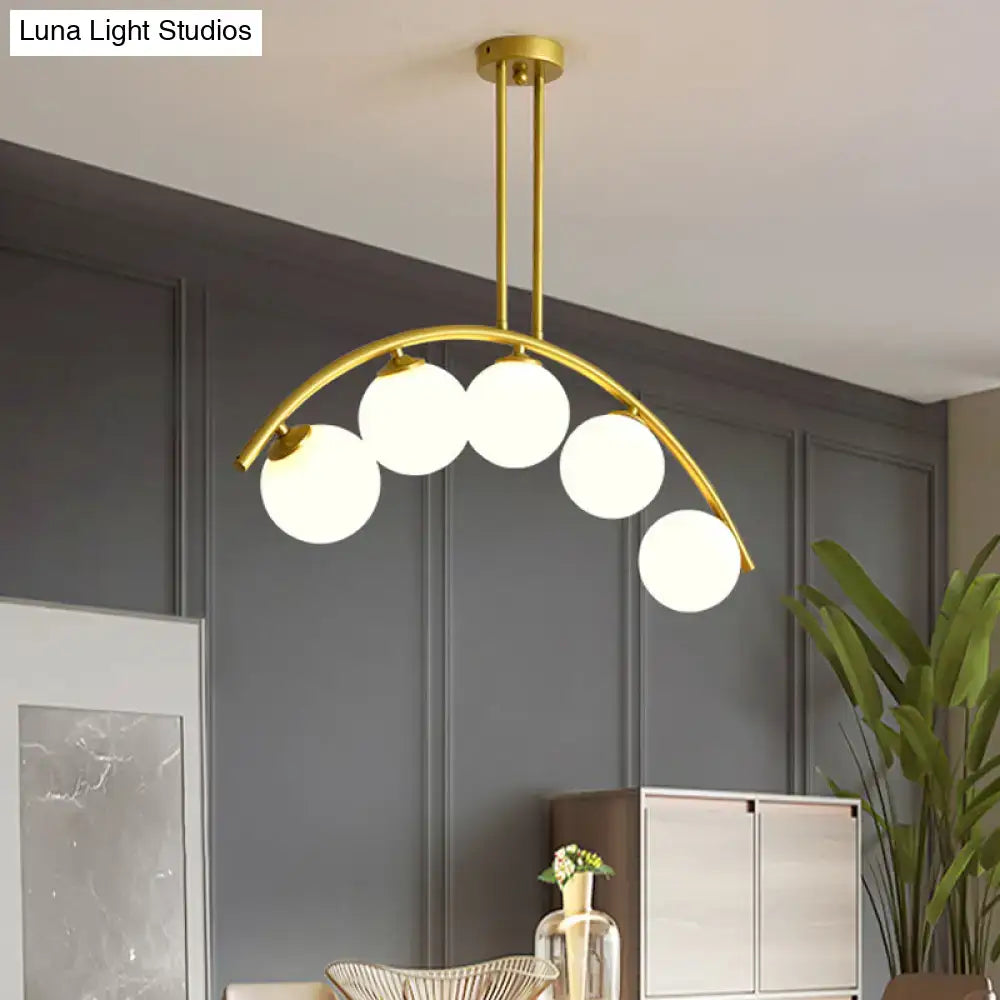 Decorbites modern glass orb pendant light with five frosted bulbs and brass arch arm in gold tone for dining room