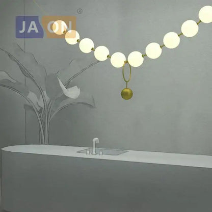 Modern brass artistic necklace chandelier pendant light with gold-toned spheres and glowing orb bulbs for living room decorbites brass artistic