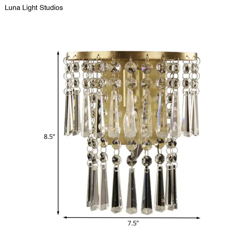 Modern brass wall sconce with gold finish and cascading clear beveled glass crystal beads for corridor lighting