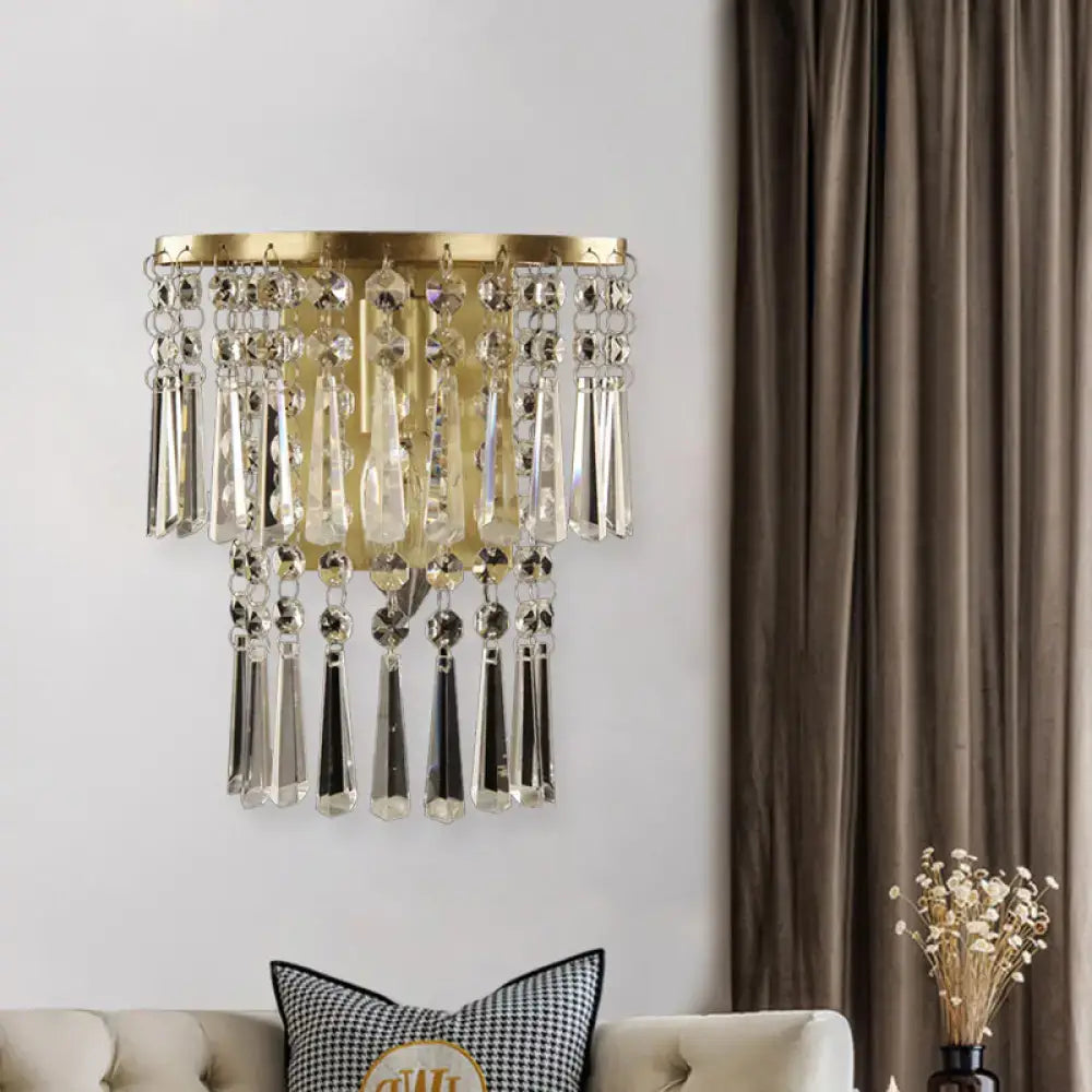 Modern brass wall sconce with gold tone and beveled glass crystal droplets for elegant corridor lighting
