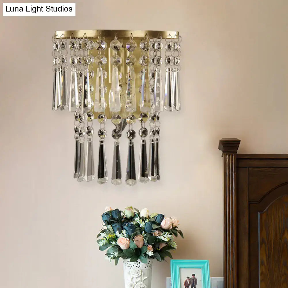Modern brass beveled glass crystal wall sconce in gold tone with cascading clear crystal droplets for corridor lighting