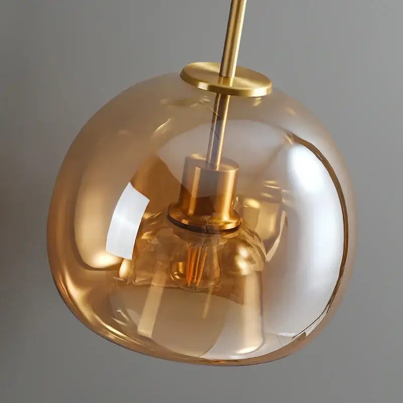 Modern brass and black glass ball led ceiling light with amber-tinted glass and polished brass finish for living room decorbites glass ball
