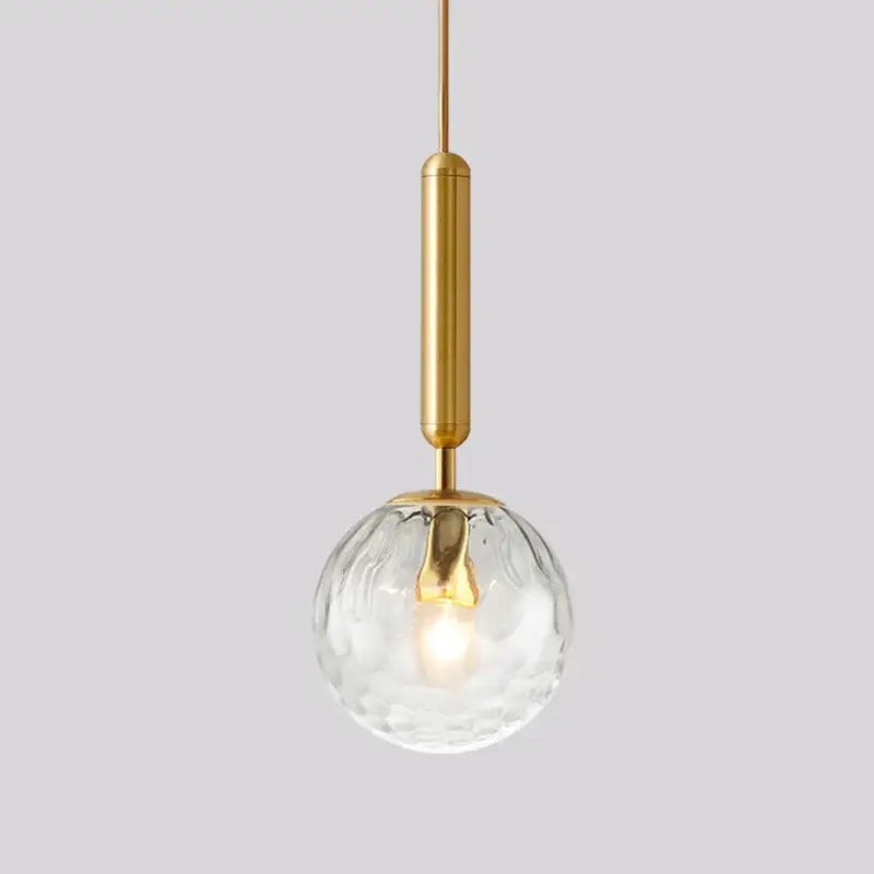 Modern brass and black decorbites glass ball pendant light with clear textured glass globe for dining room decor
