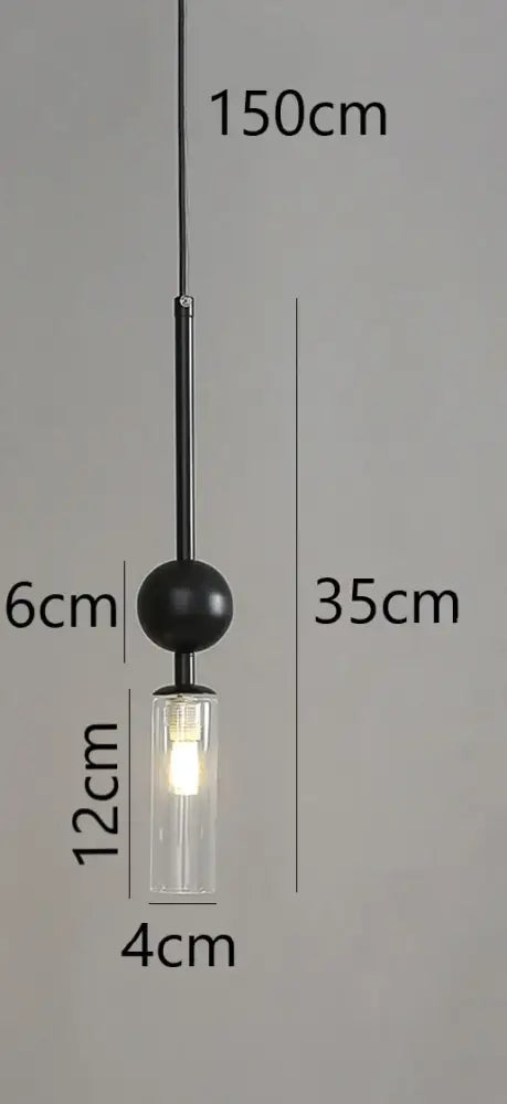 Modern brass and black glass pendant light with black spherical shade and clear glass cylinder housing led bulb suspended by chain