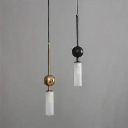 Modern brass and black glass pendant light featuring spherical accents and frosted glass with led bulb cord pendant