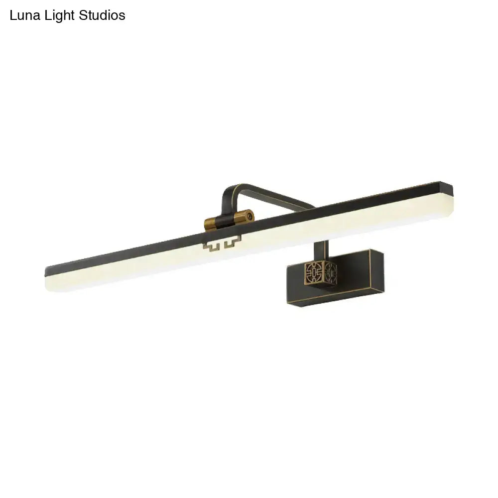Modern brass and black led wall sconce with sleek rectangular panel providing warm color temperature for dressing table