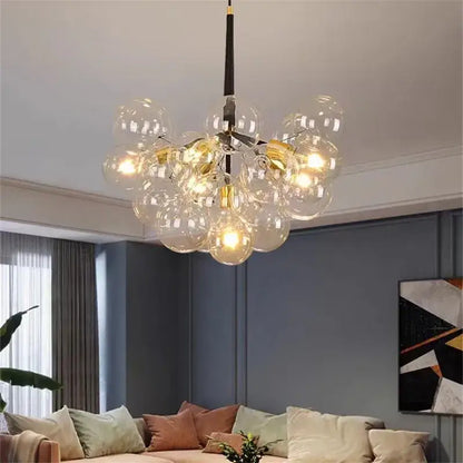 Modern brass bubble chandelier with glass bubbles warm glowing bulbs and black central rod for bedroom lighting decorbites bubble chandelier