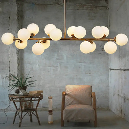 Modern brass bubbled island light fixture with frosted glass globe bulbs for dining room chandelier lighting