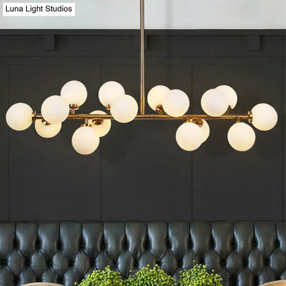 Modern brass bubbled island light fixture chandelier with gold-toned frame and frosted glass globe shades for dining room