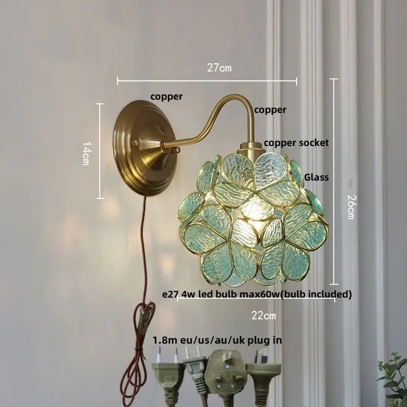 Modern brass butterfly wall sconce with brass copper finish and translucent teal flower-shaped clear glass shade by decorbites