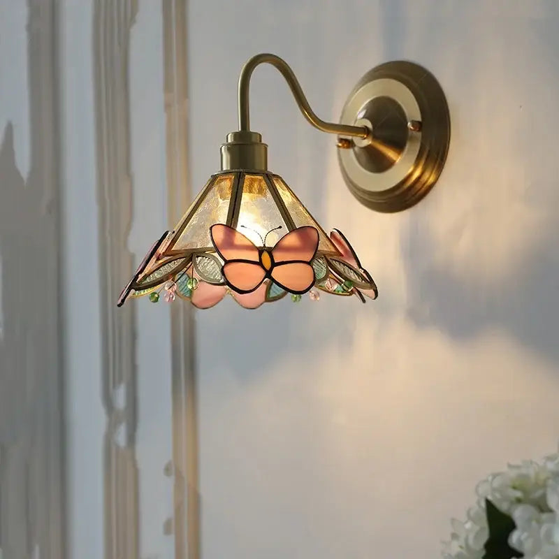 Antique brass wall sconce with stained glass shade featuring pink and peach butterfly motifs for bedroom decorbites clear glass