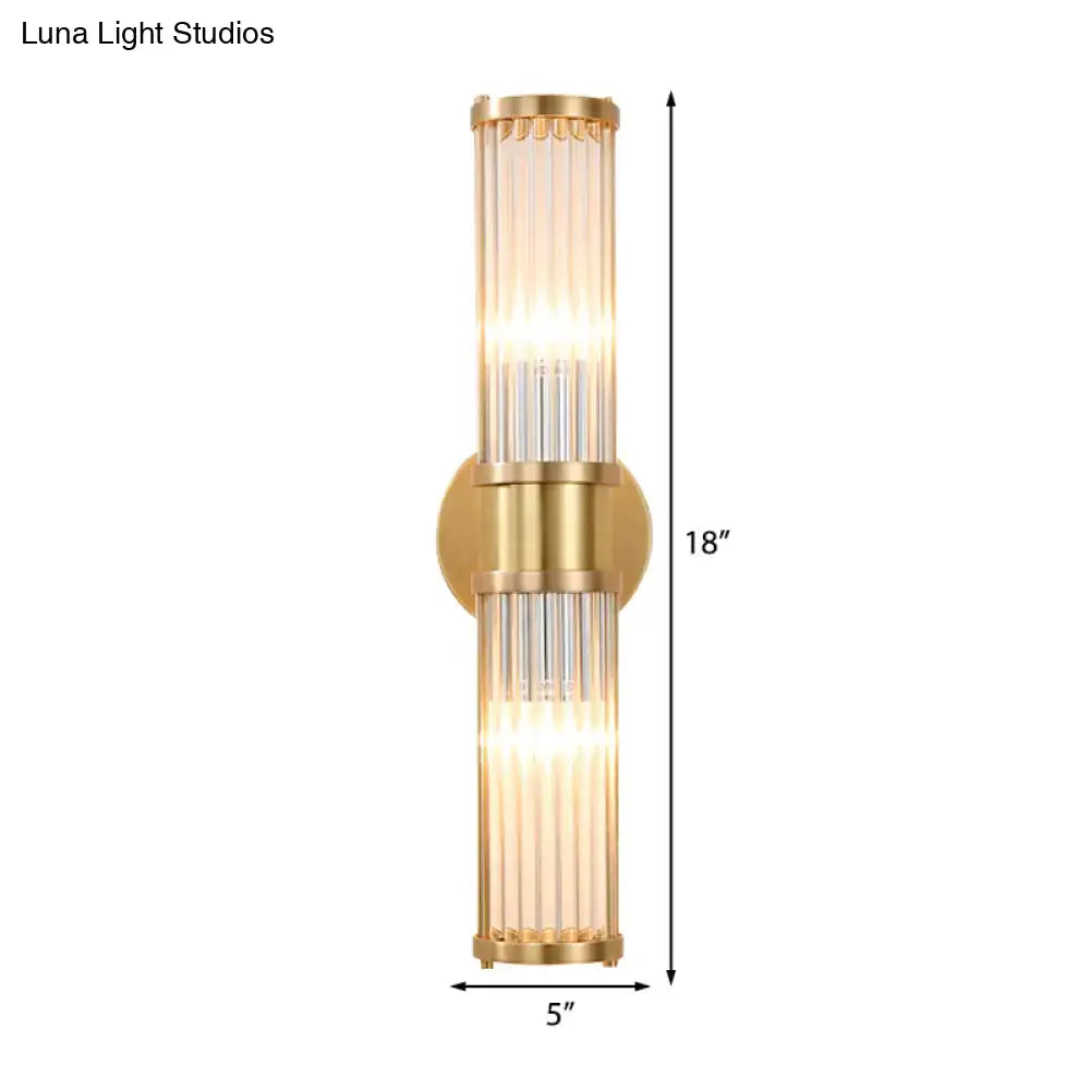 Modern brass clear crystal wall lamp with gold-toned vertical glass rods and sleek design for bedroom sconce lighting