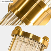 Modern brass clear crystal wall lamp with gold-toned chandelier design and polished brass finish for bedroom sconce