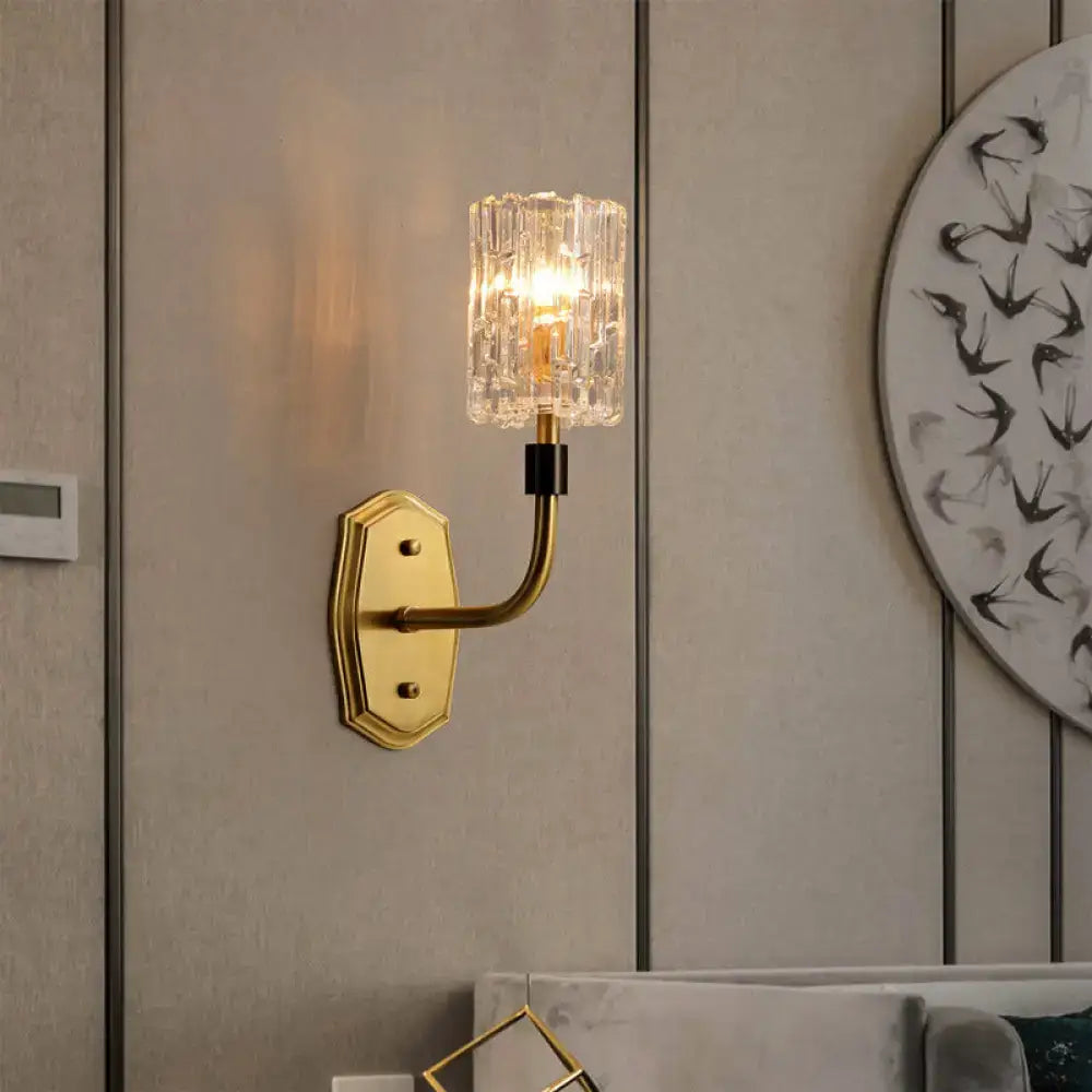 Modern brass living room wall sconce with gold-toned finish and clear faceted crystal glass shade inch fixture