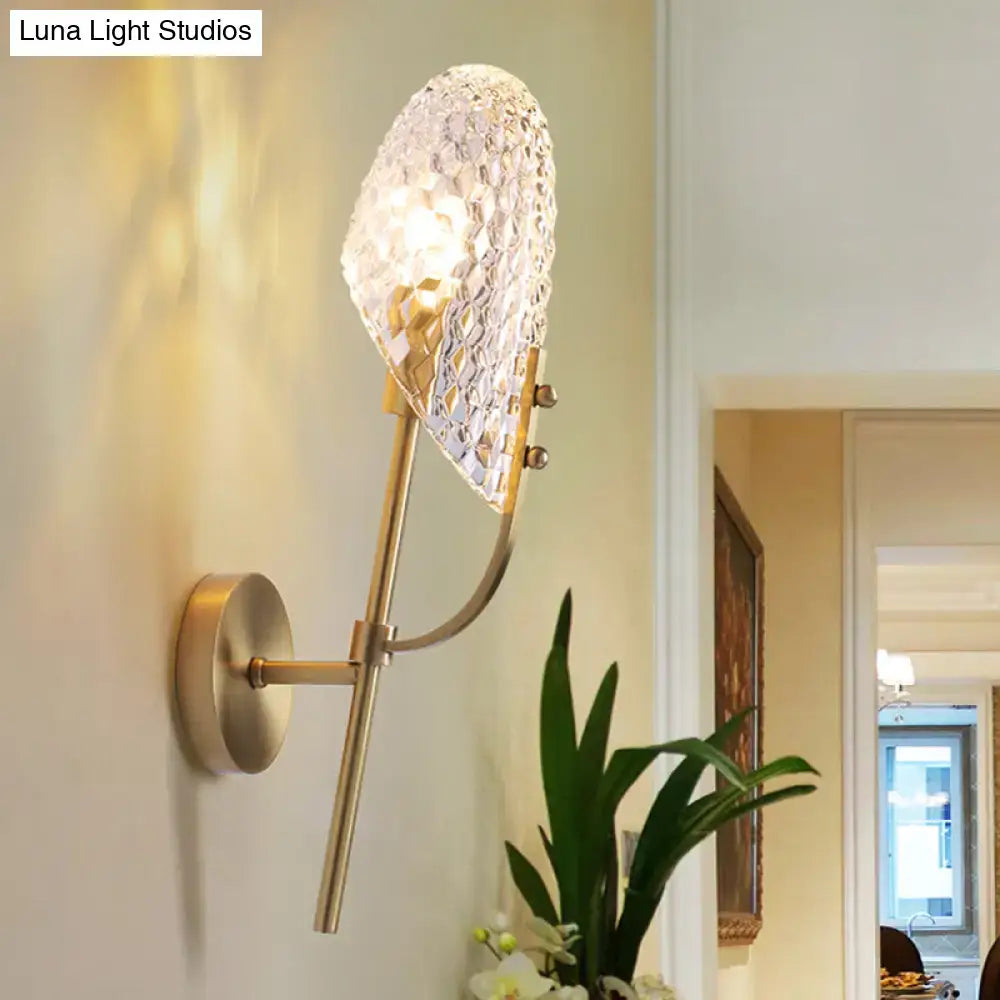 Brass-finished modern light fixture wall sconce with faceted crystal beveled shade for hallway lighting