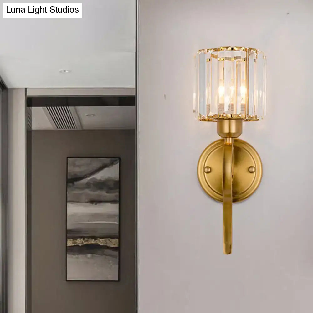 Modern brass crystal cylinder wall sconce with gold-toned finish and vertical glass prisms for bedroom lighting