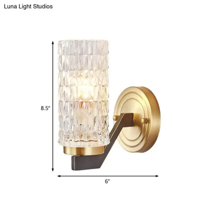 Modern brass crystal flush wall sconce with clear faceted glass cylinder and gold-toned metal wall lamp base