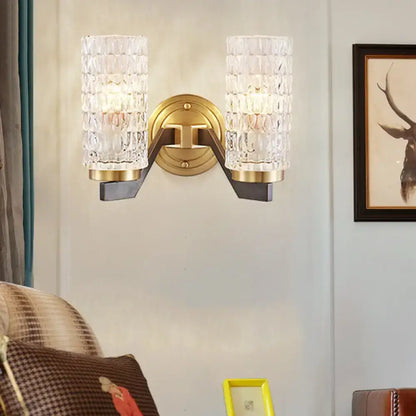 Modern design flush wall sconce with brass finish and two textured crystal glass shades for bedroom wall lamp use