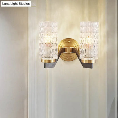 Modern brass flush wall sconce with gold-toned finish and two textured crystal glass shades for bedroom wall lamp