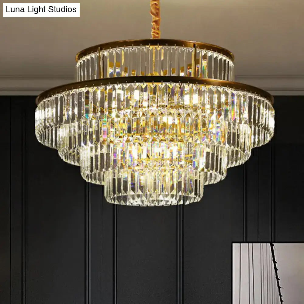 A multi-tiered crystal chandelier with gold-toned metal frame and clear faceted crystals for living room use