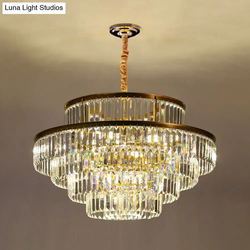 A multi-tiered decorbites modern crystal prism pendant light with gold-toned metal frame and rope suspension for living room