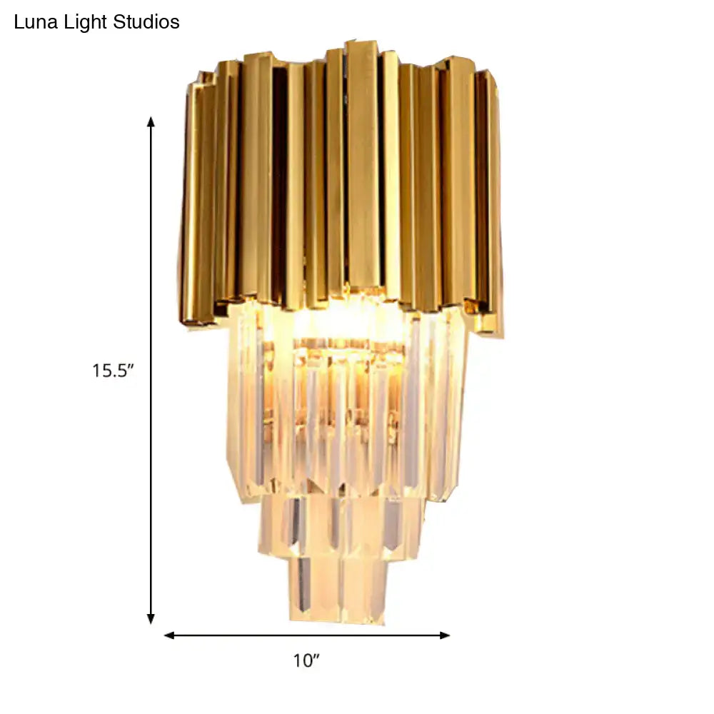 Modern brass wall lamp with gold-toned finish and tiered crystal prisms direct wired electric for living room use