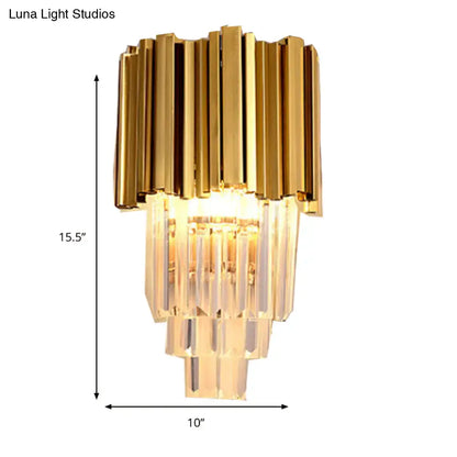 Modern brass wall lamp with gold-toned finish and tiered crystal prisms direct wired electric for living room use