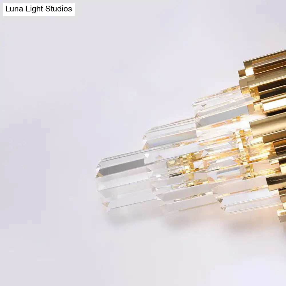 A modern brass wall lamp with clear crystal prisms and a gold-toned frame direct wired electric for living room