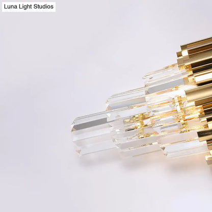 A modern brass wall lamp with clear crystal prisms and a gold-toned frame direct wired electric for living room