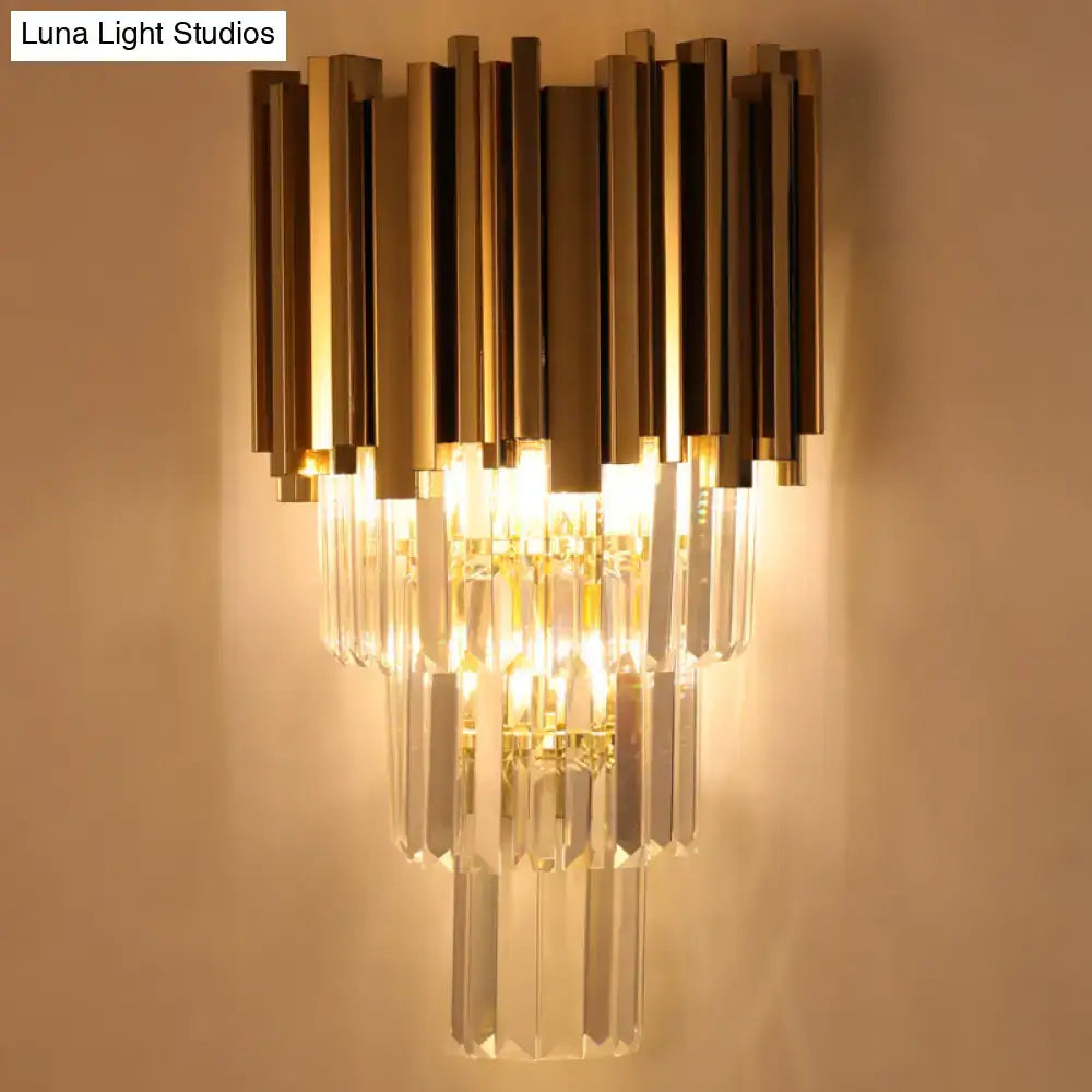 Modern brass wall lamp with gold-toned metal and clear crystal prisms direct wired electric for living room use