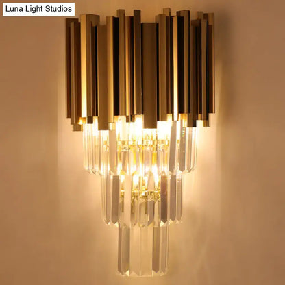 Modern brass wall lamp with gold-toned metal and clear crystal prisms direct wired electric for living room use