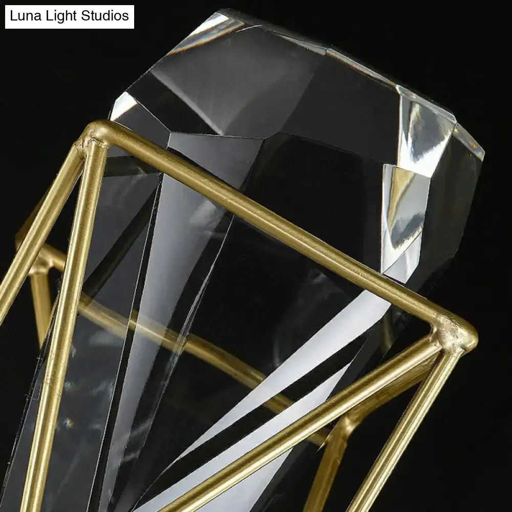 A clear crystal rock diamond-shaped planter with a gold-toned metal frame and modern brass fixture width design