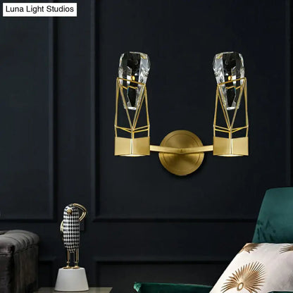 Modern brass crystal rock wall sconce featuring a gold-toned geometric fixture with faceted crystal accents and fixture width details