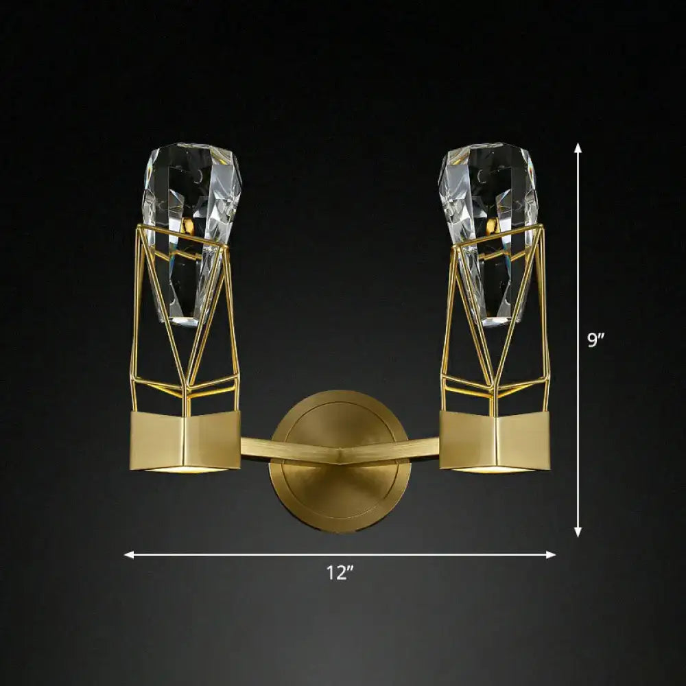 Modern brass crystal rock wall sconce with gold-toned geometric metal frame and two faceted crystal fixtures, ideal for bedrooms