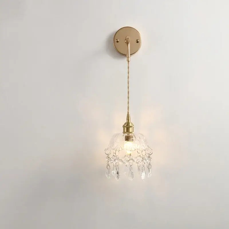 Modern brass crystal wall lamp with a delicate gold-toned frame clear glass shade and crystal droplets for bathroom decorbites clear glass