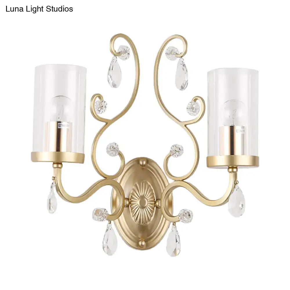 Modern brass crystal wall mounted light featuring gold-toned ornate design with crystal teardrop accents and glass shades