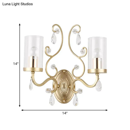 Modern brass crystal wall mounted light with gold-toned curved arms and glass shades featuring crystal teardrop accents