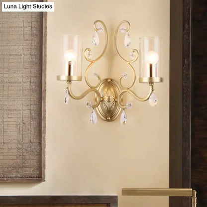 Modern brass crystal wall mounted light with gold-toned ornate design and clear glass shades for bedroom use