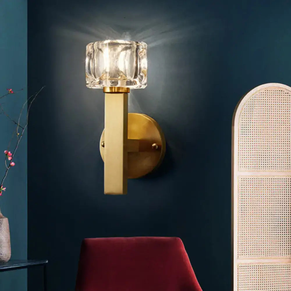 Modern brass crystal wall sconce with faceted clear crystal shade and polished brass finish for contemporary cube flush lighting