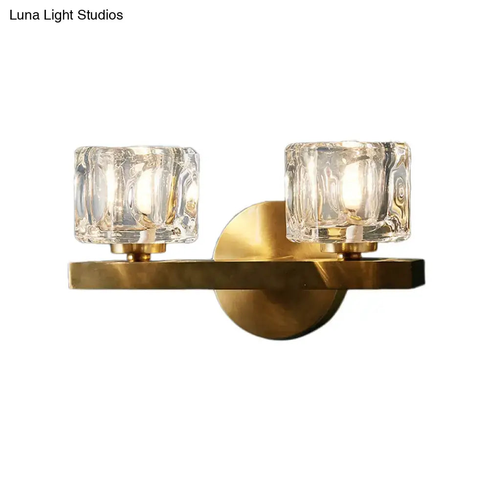 Modern brass crystal wall sconce with two textured glass shades in a contemporary cube flush design for bedroom lighting