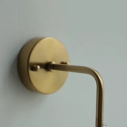 Modern brass cube led wall light with brass-finished curved arm and circular base for decorbites led wall lighting