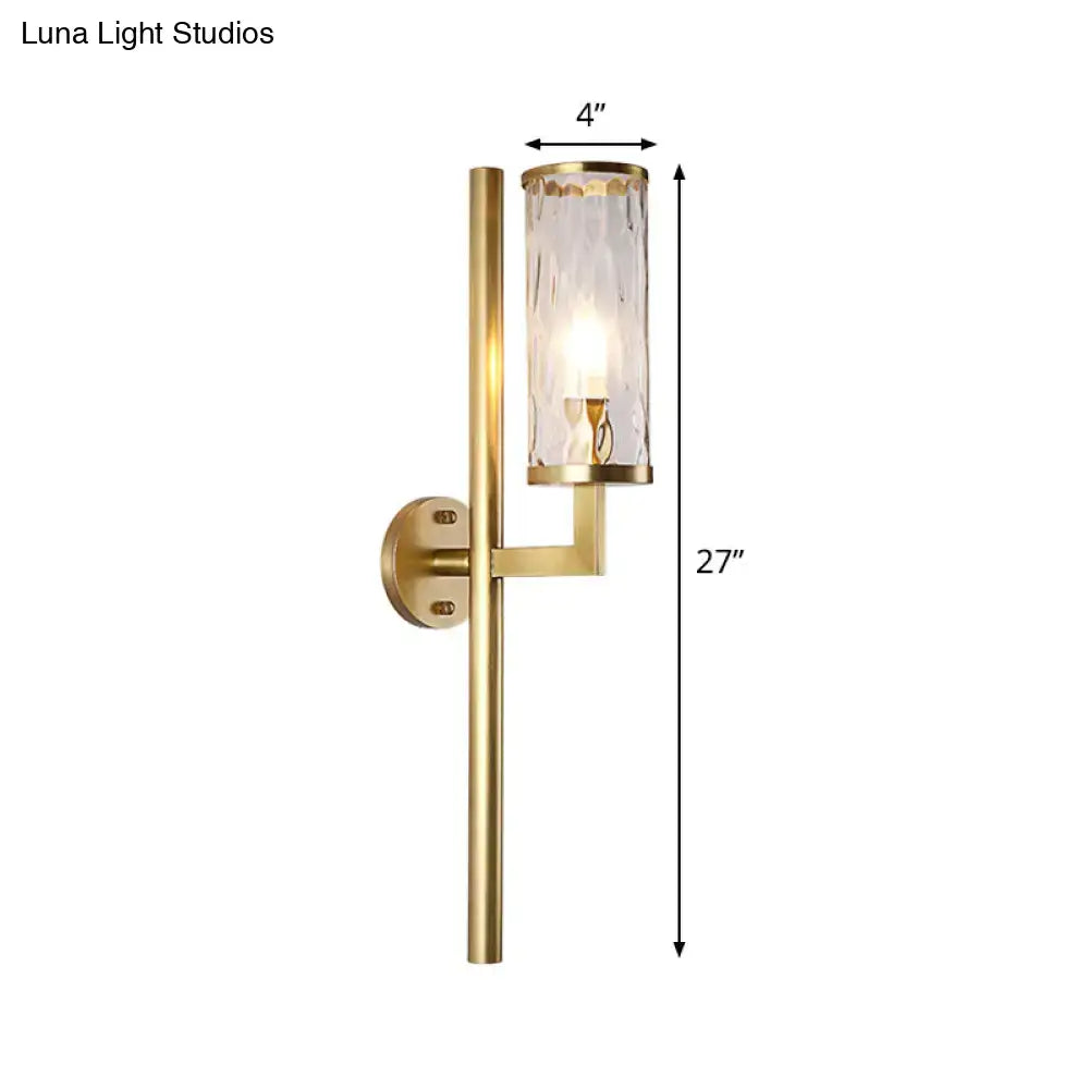 Modern brass cylinder sconce with gold finish brass bracket and clear water glass textured cylinder for bedroom wall lamp