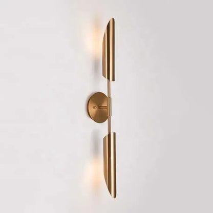Modern brass cylindrical wall light with sleek elongated shades and minimalist circular base for decorbites golden luxury decor
