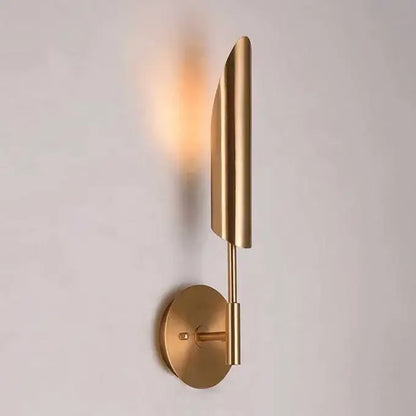 Modern brass cylindrical wall light with brushed gold finish and leaf-inspired design for golden luxury wall decorbites wall light