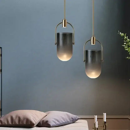 Two modern pendant lights with brass metal frames and gradient gray glass shades from decorbites bucket chandelier