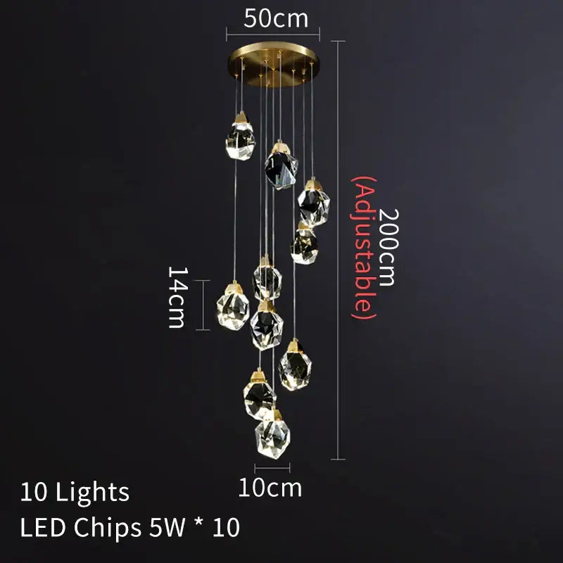 A modern brass decorbites crystal led chandelier with ten clear glass pendants hanging from a gold ceiling mount