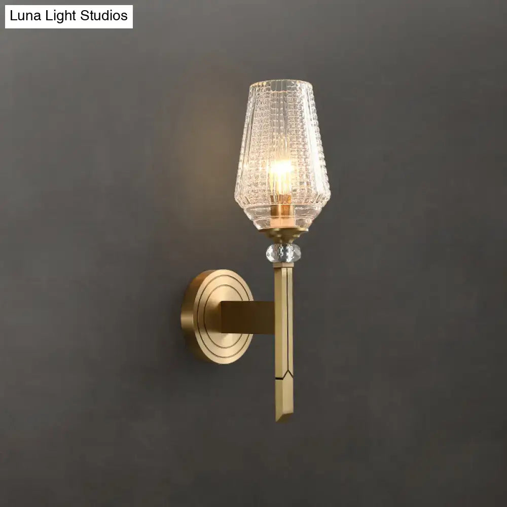 Modern brass wall light with lattice glass shade, textured clear glass, and crystal accent bead for bedroom use