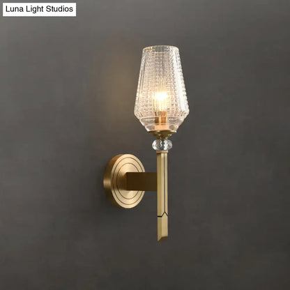 Modern brass wall light with lattice glass shade, textured clear glass, and crystal accent bead for bedroom use