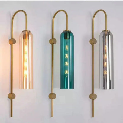 Three modern brass e27 glass wall lights with amber teal and mirrored silver cylindrical shades for bedroom use