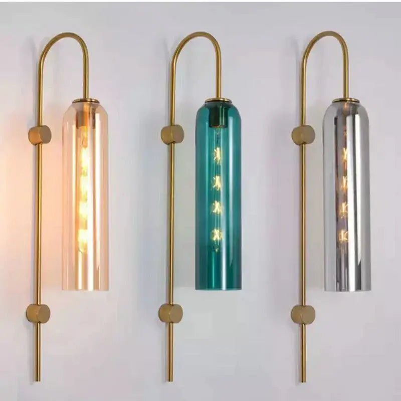 Three modern brass e27 glass wall lights with amber teal and mirrored silver cylindrical shades for bedroom use